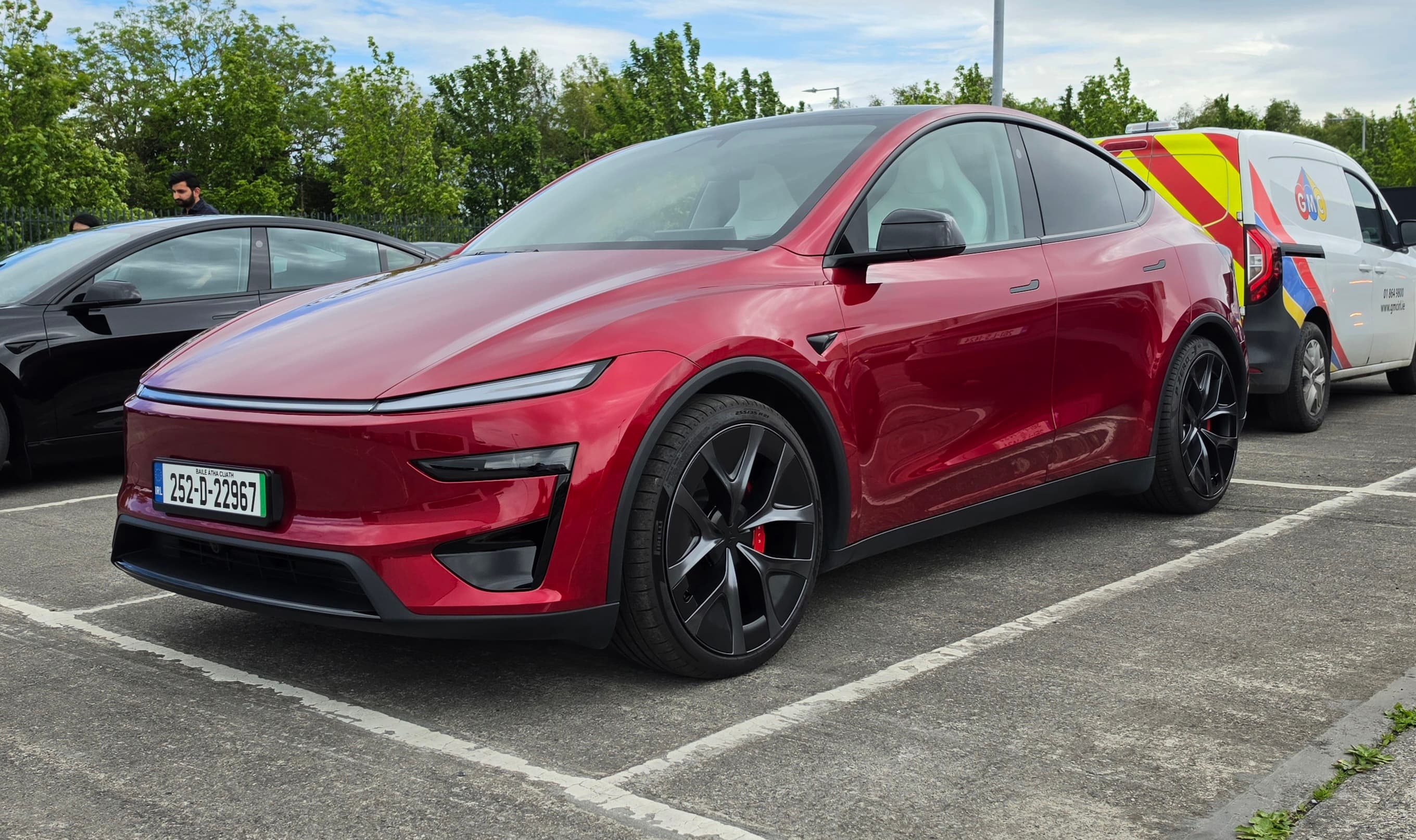 John’s red Tesla Model Y, photographed outdoors
